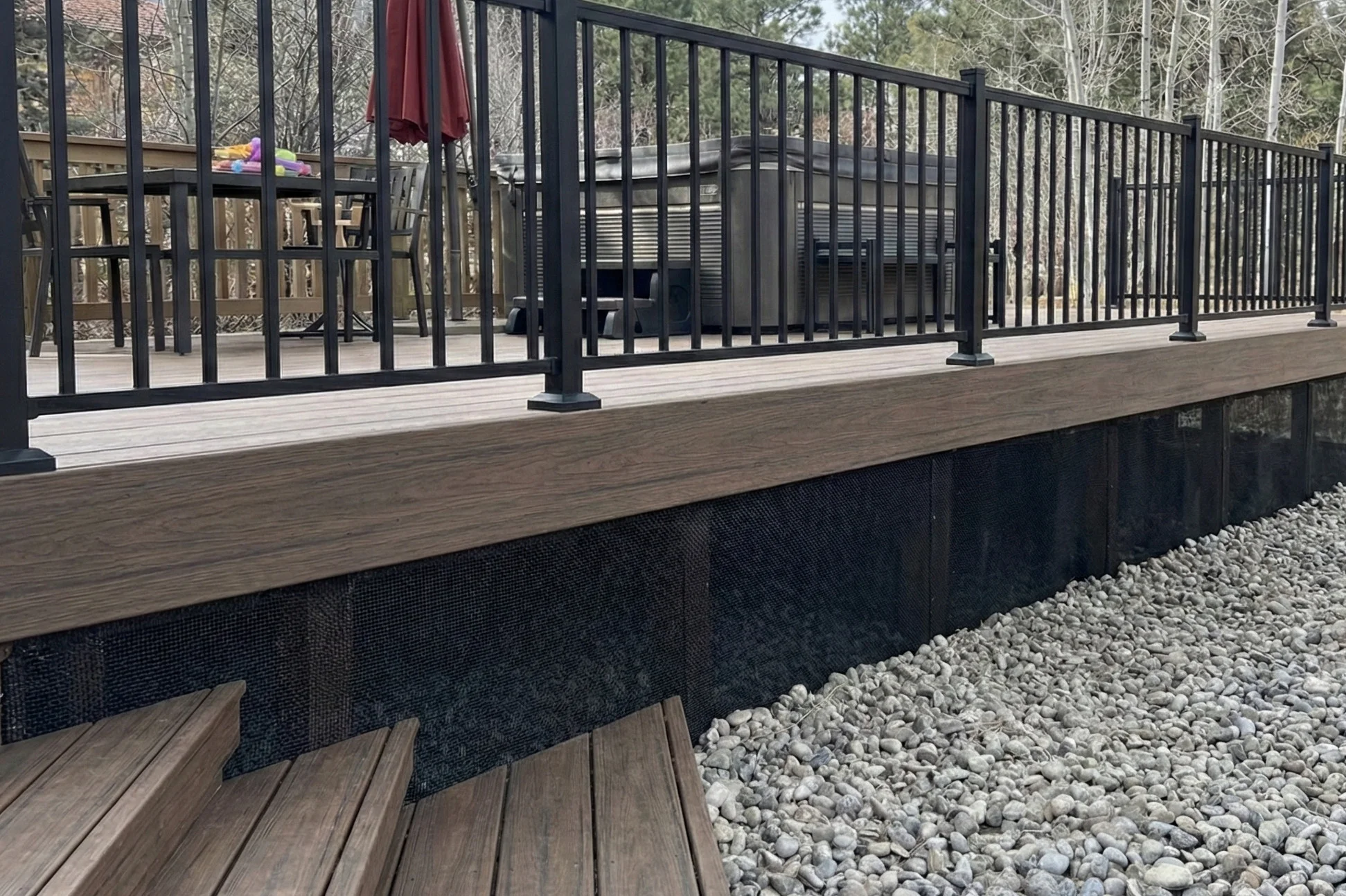 Under deck screening with non-combustible mesh